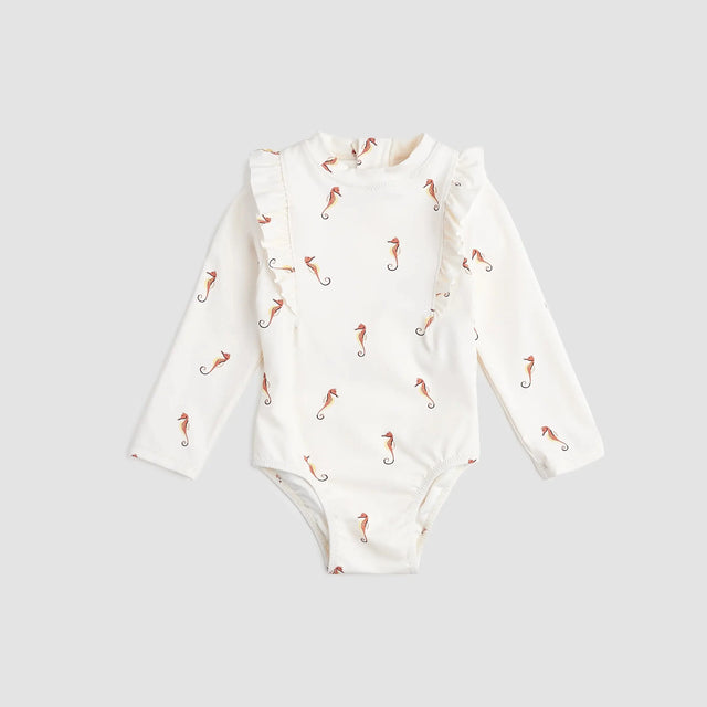 Miles The Label baby girls and girls Creme seahorse long-sleeve swimsuit with UPF 50+ and frilly shoulders.