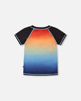 Back view of blue and orange gradient short sleeve rashguard with contrast black sleeves