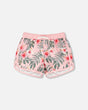Front flat lay of Deux par Deux girl pink hibiscus girls swim shorts with curved hem