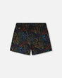 Front flat lay of Deux par Deux baby and boy black dinosaur boys swim trunks