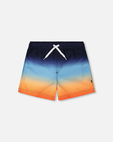 Front flat lay of Deux par Deux boy blue and orange gradient boys swim trunks