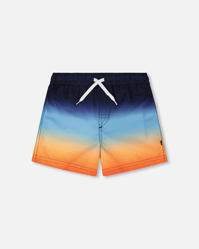 Front flat lay of Deux par Deux boy blue and orange gradient boys swim trunks
