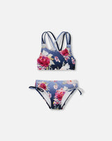 Flat lay of Deux par Deux girl Blue Rose two-piece swimsuit with strappy top and side-tie bottoms