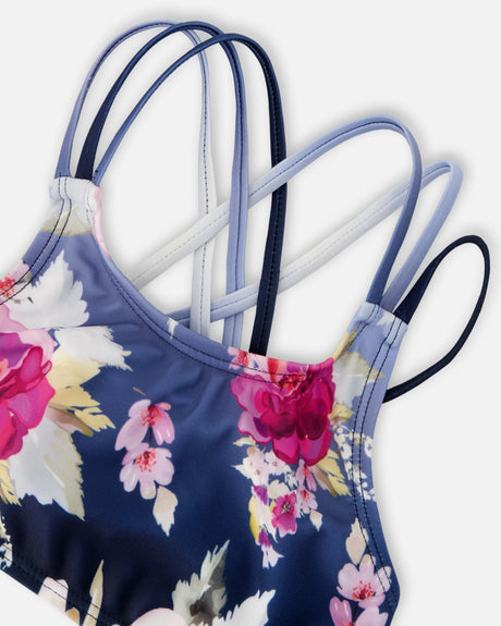 Detail shot of floral print and side-tie bottoms on blue rose two-piece swimsuit