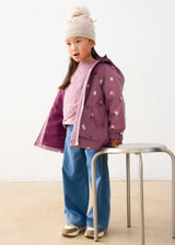 Girl wearing open mauve heart-print hooded raincoat