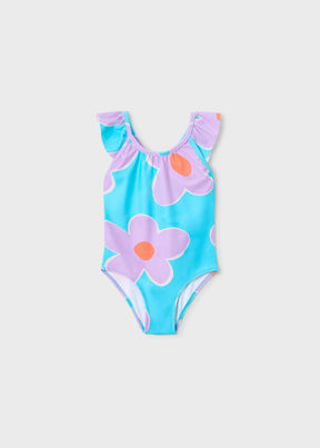 Front view of aqua Mayoral girls swimsuit with oversized lilac flowers and ruffled straps