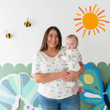 Adult holding baby in matching Kyte Baby Caterpillar print outfit