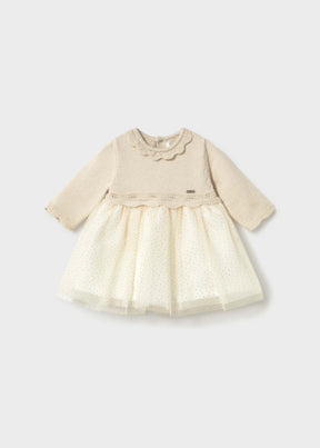 Front view of ivory Mayoral newborn girl dress with scalloped collar and gold-dot tulle skirt