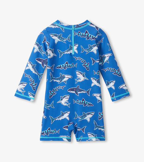 Back view of baby boy one-piece shark swimsuit showing long sleeves and all-over ocean-inspired print.