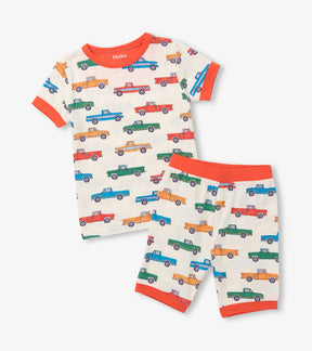 Hatley boys Trucks short pajama set in cream with colourful pickups and orange trim